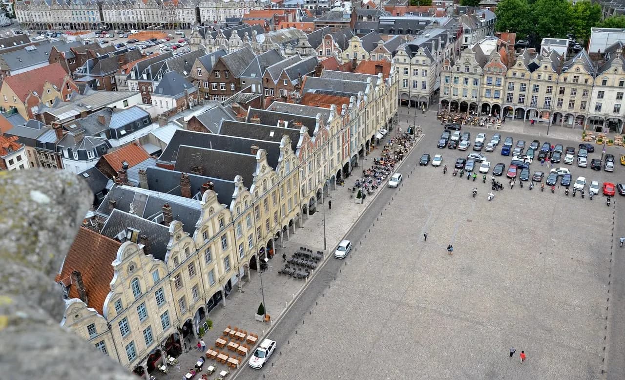 An aerial view captures the historic Grand'Place, with its unique gabled buildings and a large open square.