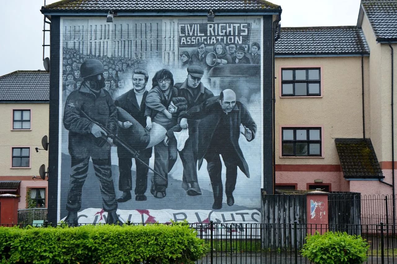 A large mural depicting the Civil Rights Association is painted on the side of a building, a historic landmark in the city.