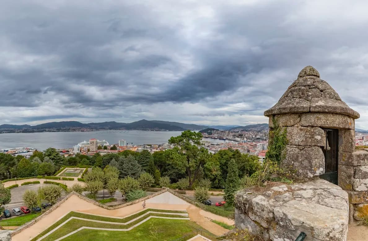 A small stone guard tower is a prominent feature of a park with a panoramic view of the Vigo bay and city below.